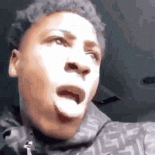 A Young Man Is Making A Funny Face With His Mouth Open And His Tongue Out . GIF