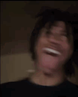 A Young Man Is Making A Funny Face With His Tongue Out . GIF