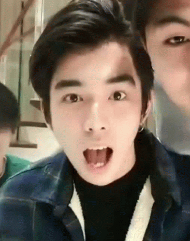 A Young Man Is Making A Funny Face With His Tongue Sticking Out . GIF