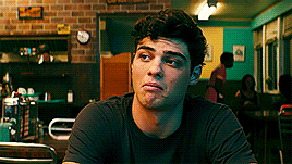 A Young Man Is Sitting At A Table In A Diner . GIF