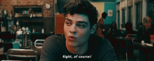 A Young Man Is Sitting At A Table In A Restaurant And Talking To Someone . GIF