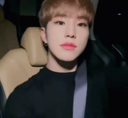 A Young Man Is Sitting In The Driver 'S Seat Of A Car . GIF