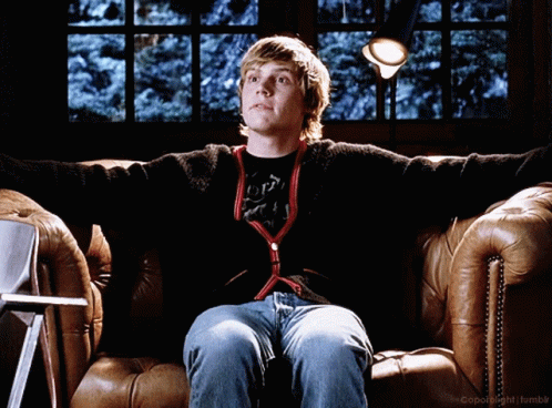 A Young Man Is Sitting On A Couch With His Arms Outstretched In Front Of A Window With The Words Copyright Tumblr On The GIF