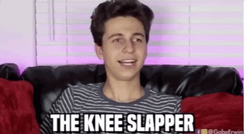 A Young Man Is Sitting On A Couch With The Words " The Knee Slapper " Above Him GIF