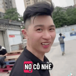 A Young Man Is Smiling And Making A Funny Face While Wearing A Black Shirt And A Backpack . GIF