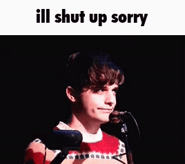 A Young Man Is Standing In Front Of A Microphone With The Words `` Ill Shut Up Sorry '' Written Above Him . GIF