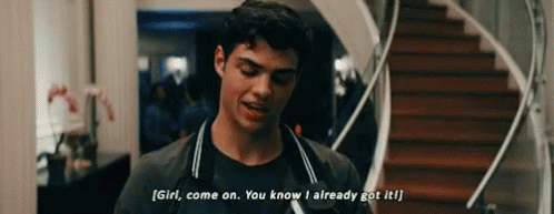 A Young Man Is Standing In Front Of A Staircase And Talking To A Girl . GIF