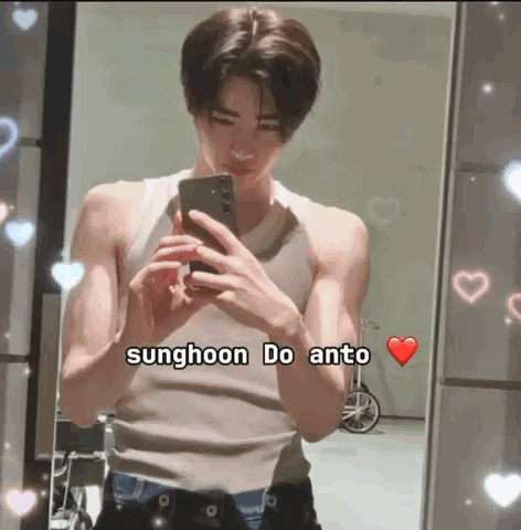 A Young Man Is Taking A Selfie In Front Of A Mirror While Wearing A Tank Top . GIF