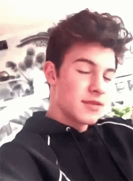 A Young Man Is Taking A Selfie With His Eyes Closed . GIF