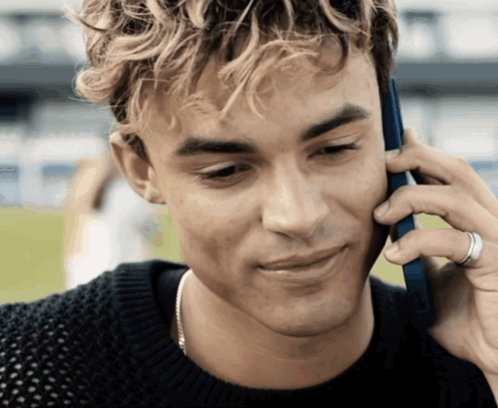 A Young Man Is Talking On A Cell Phone GIF