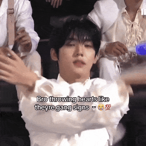 A Young Man Is Throwing Hearts Like Theyre Gang Signs GIF