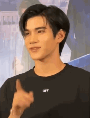 A Young Man Is Wearing A Black T-Shirt With The Word Off On It . GIF