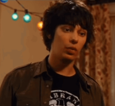 A Young Man Is Wearing A Shirt That Says Brat On It GIF