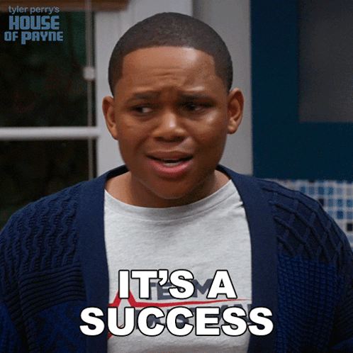 A Young Man Is Wearing A Sweater And A Shirt That Says " It 'S A Success " GIF