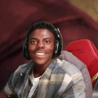 A Young Man Is Wearing Headphones And Smiling While Sitting In A Red Chair . GIF