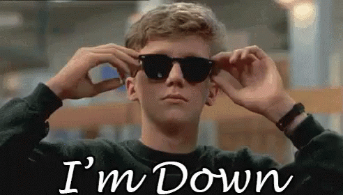 A Young Man Is Wearing Sunglasses And The Words `` I 'M Down '' Are Written On The Screen Behind Him . GIF