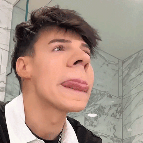 A Young Man Making A Face With His Tongue Out GIF