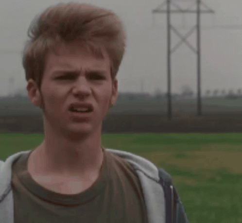 A Young Man Making A Funny Face In A Field GIF