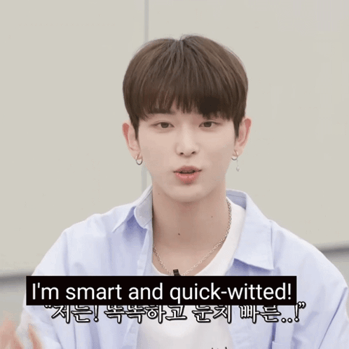 A Young Man Pointing At The Camera With The Words I 'M Smart And Quick-Witted Behind Him GIF