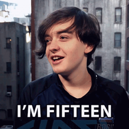 A Young Man Says I 'M Fifteen In Front Of Buildings GIF