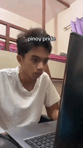 A Young Man Sitting In Front Of A Laptop With The Word Pinoy Pride Written On His Face GIF