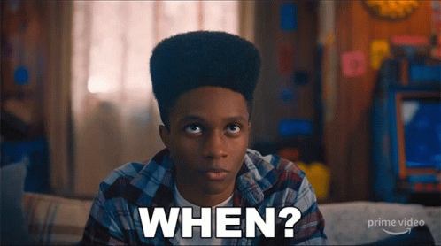 A Young Man Sitting On A Couch With The Words When Written On His Face GIF