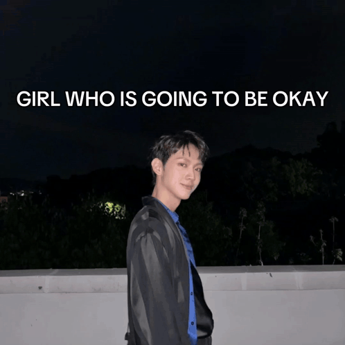 a young man stands in front of a poster that says girl who is going to be okay