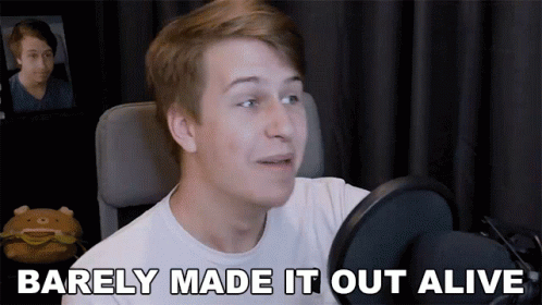 A Young Man Talking Into A Microphone With The Words Barely Made It Out Alive Above Him GIF