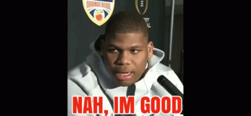 A Young Man Talking Into A Microphone With The Words " Nah Im Good " In Red Letters GIF