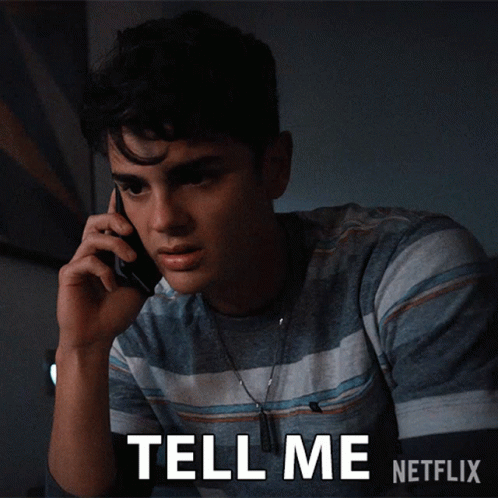 A Young Man Talking On A Cell Phone With The Words Tell Me Netflix Written Below Him GIF