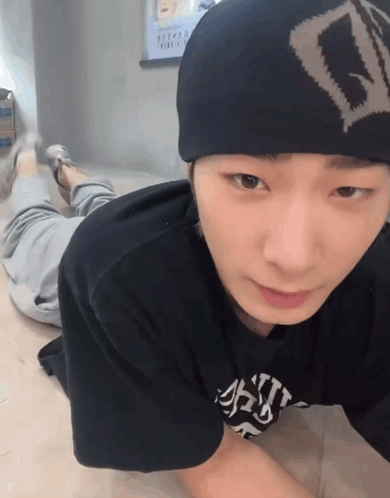 A Young Man Wearing A Beanie And A T-Shirt That Says ' A ' On It GIF