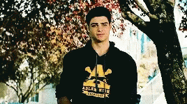 A Young Man Wearing A Black Adler High Hoodie GIF