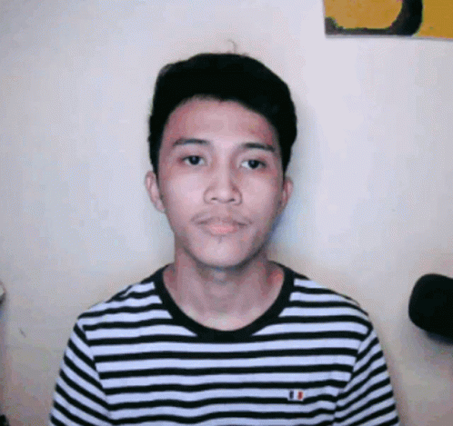 A Young Man Wearing A Black And White Striped Shirt With A French Flag On It GIF