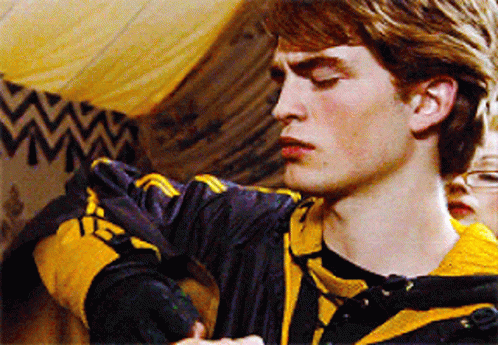 A Young Man Wearing A Black And Yellow Striped Shirt With The Letter H On It GIF