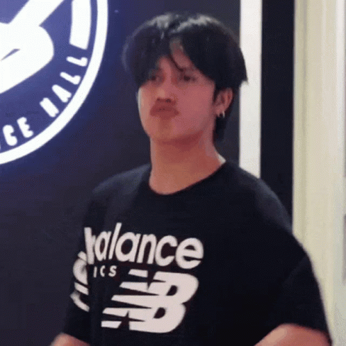 A Young Man Wearing A Black Balance Ics T-Shirt GIF