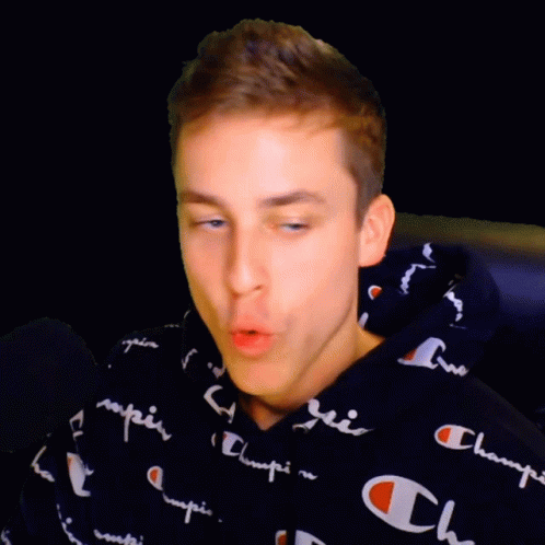 A Young Man Wearing A Black Champion Hoodie GIF