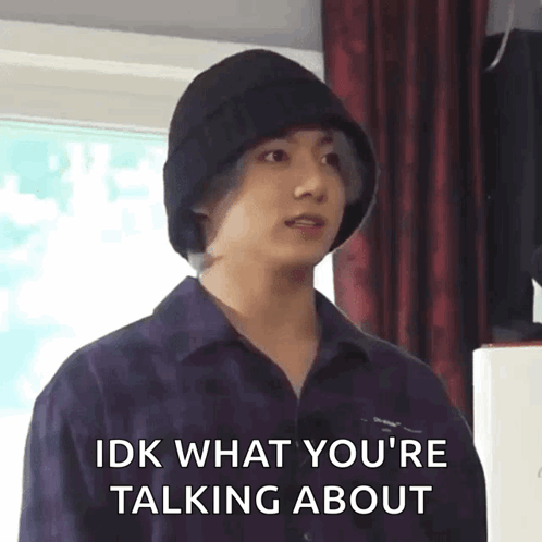 A Young Man Wearing A Black Hat Is Talking About Something . GIF