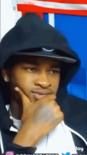 A Young Man Wearing A Black Hoodie And A Hat Is Thinking . GIF