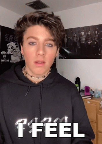 A Young Man Wearing A Black Hoodie That Says " I Feel " GIF