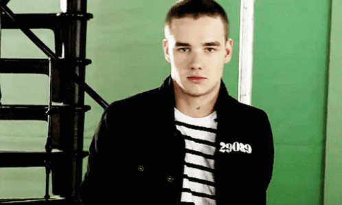 A Young Man Wearing A Black Jacket With The Number 29089 On His Chest GIF