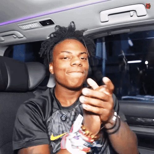 A Young Man Wearing A Black Nike Shirt Is Clapping His Hands GIF