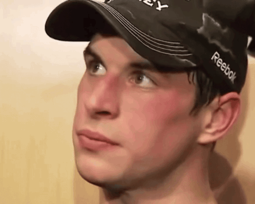 A Young Man Wearing A Black Reebok Hat GIF