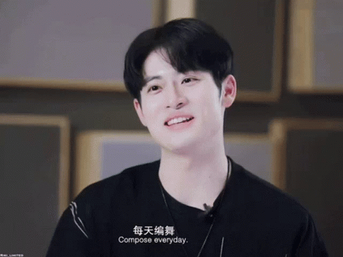 A Young Man Wearing A Black Shirt And A Necklace Says Compose Everyday GIF