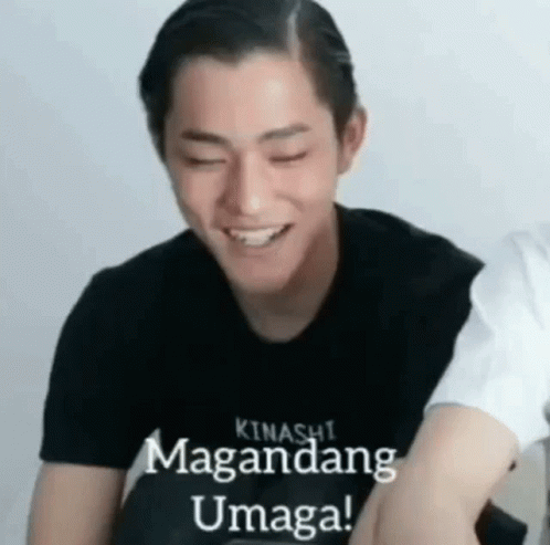 A Young Man Wearing A Black Shirt Is Smiling With His Eyes Closed And The Words `` Kinashi Magandang Umaga '' Written On GIF