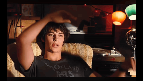 A Young Man Wearing A Black Shirt That Says Oakland Prs GIF