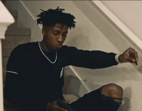 A Young Man Wearing A Black Sweater With The Word Freedom On It GIF