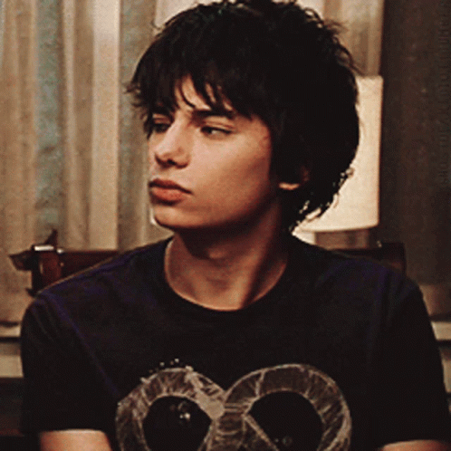 A Young Man Wearing A Black T-Shirt With A Skull On It GIF
