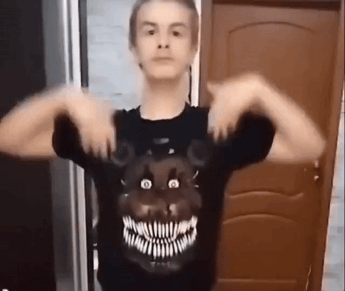 A Young Man Wearing A Black T-Shirt With A Teddy Bear Face On It . GIF