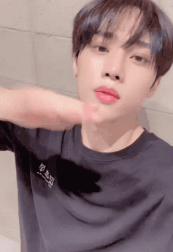 A Young Man Wearing A Black T-Shirt With Chinese Characters On The Front GIF