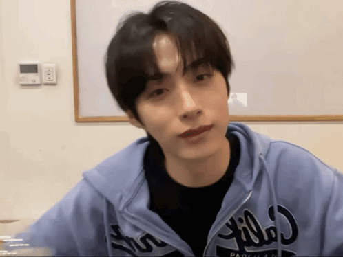 A Young Man Wearing A Blue Hoodie That Says ' Pacifica ' On It GIF